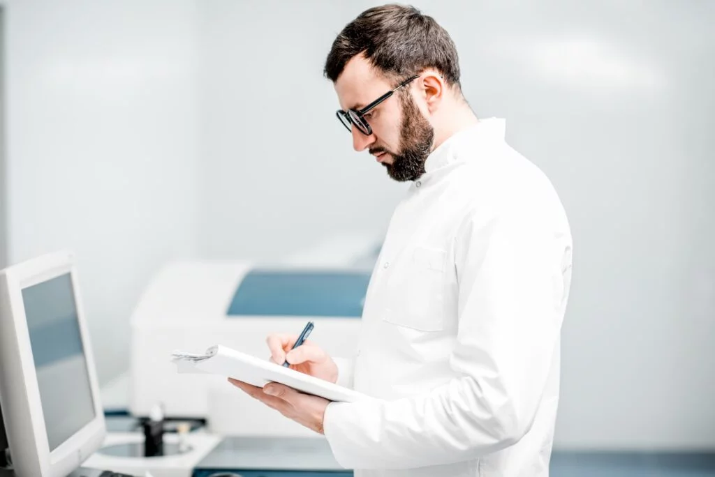 Doctor writing on a clipboard.