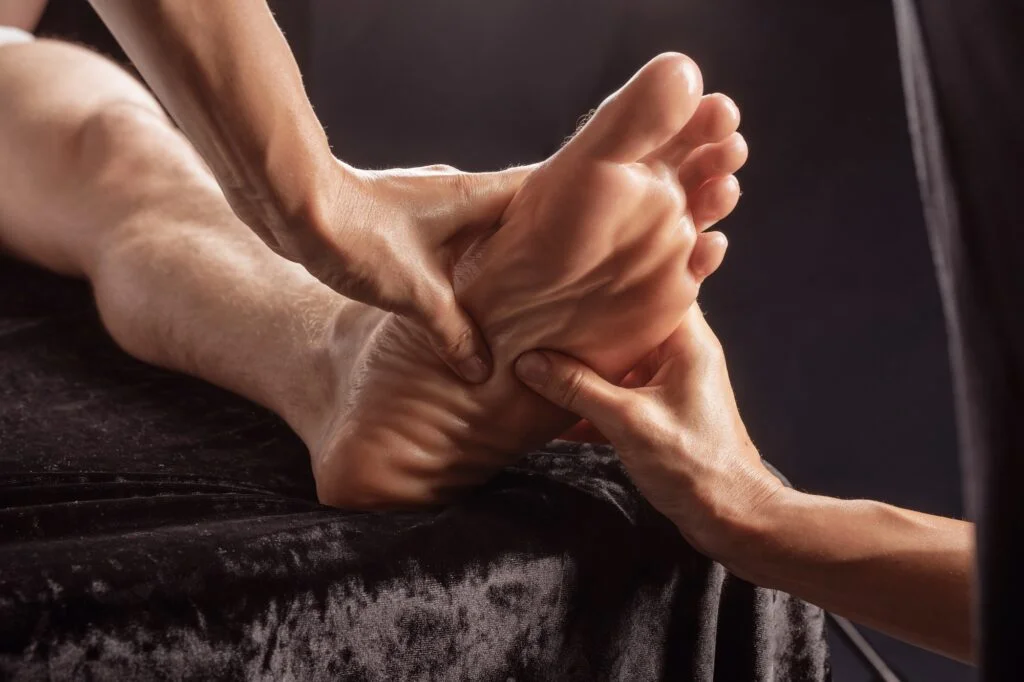 Hands massaging a foot