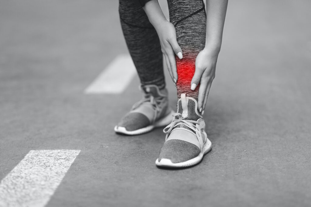 Person holding their leg in pain