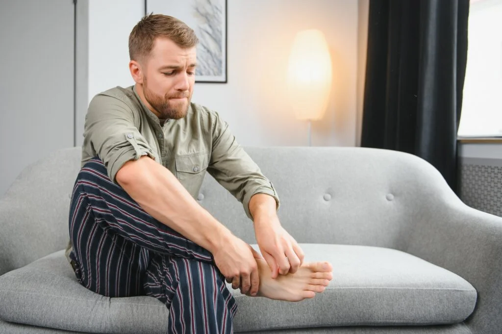 Man scratching his foot