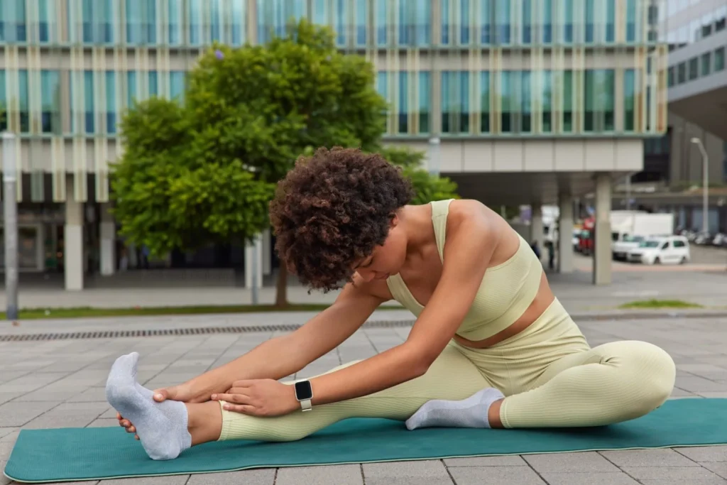 Person stretching foot and ankle on an exercise mat