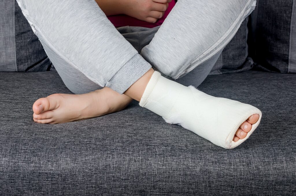 Person sitting with a cast on one foot.